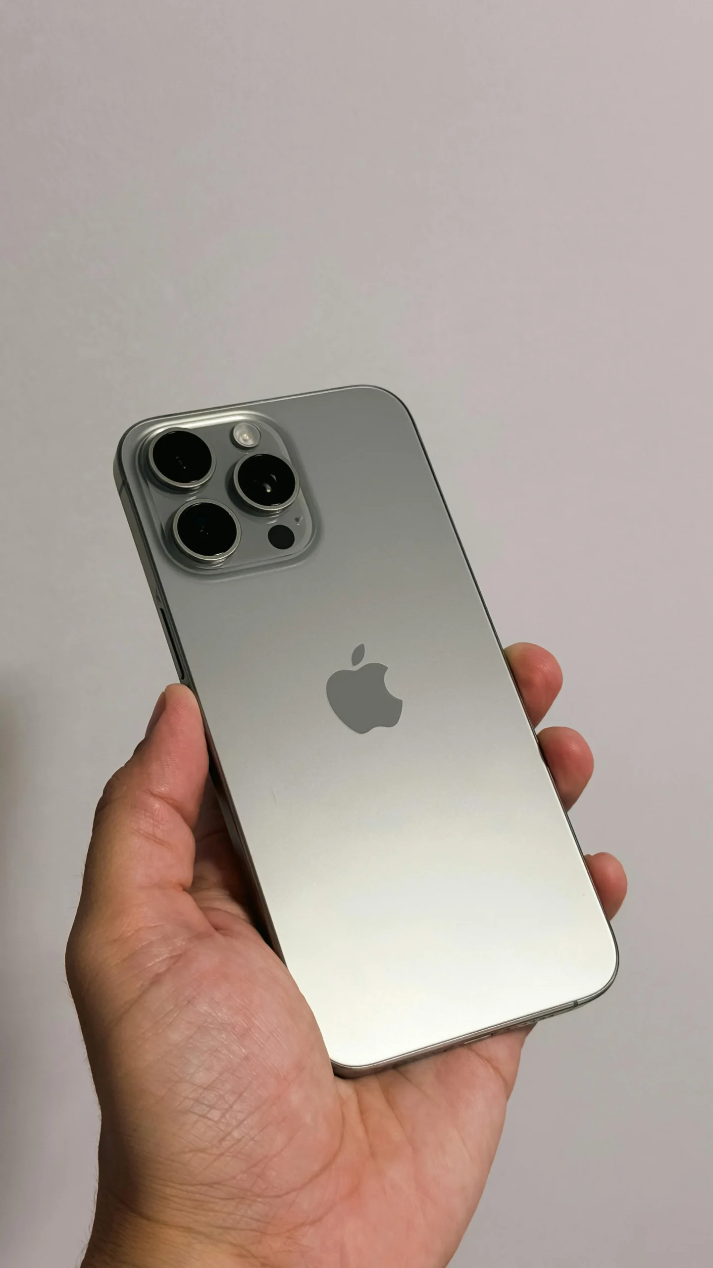 iPhone Pro Max in hand, titanium finish flagship smartphone